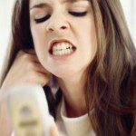 Woman grimacing at phone