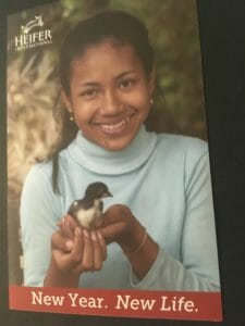 Girl holding chick